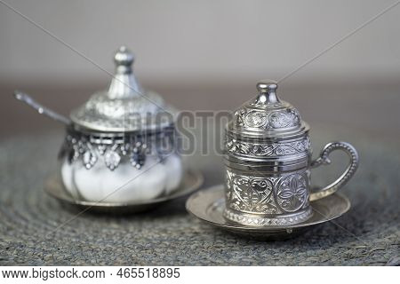 Silver Coffee Cup And Silver Sugar Jars.close Up.