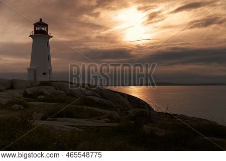 The Peggys Cove Lighthouse At Sunset, Nova Scotia, Canada. High Quality Photo