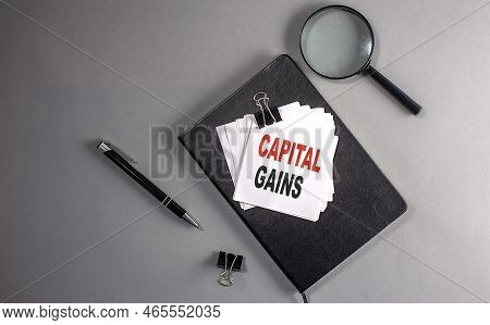 Capital Gains Text On Sticky On Black Notebook , Business Concept