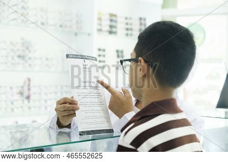 Smart Young Buy Student In Striped Polo T-shirt Trying Out, Testing, And Choosing New Eyeglasses Loo