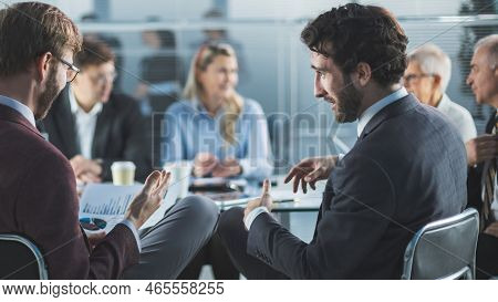 Rear View. Business Colleagues Discussing The Financial Schedule