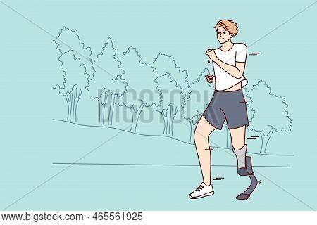 Smiling Young Man With Prosthetic Leg Running In Park. Happy Disabled Male With Prosthesis Jogging T