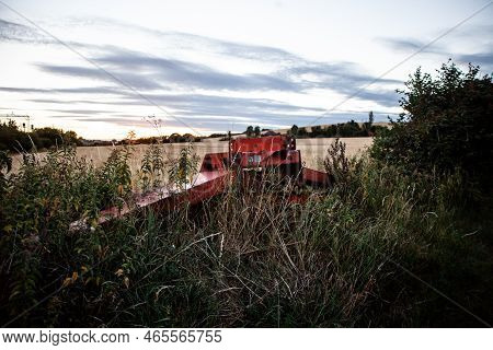 Derelict Agriculture Equipment Overgrown On Edge Of Field