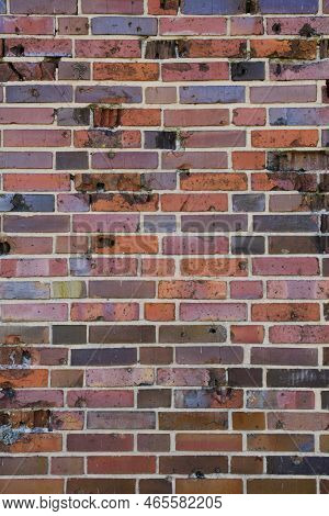 Background, Brick Wall Made Old German Red Burnt Brick With Traces Bullets And Shrapnel After World 