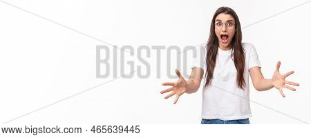 Watch Out. Alarmed And Shocked, Scared Pretty Girl Raising Hands To Catch Something That Person Thro