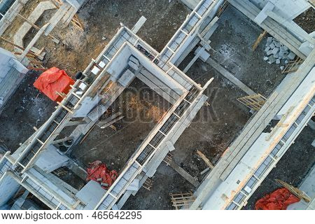 Aerial View Of Unfinished Frame Of Private House Foundation Under Construction.