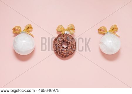 White Christmas Balls Wiht Chocolate Donut And Golden Bows. New Year Adorn Creative Decoration On Pi