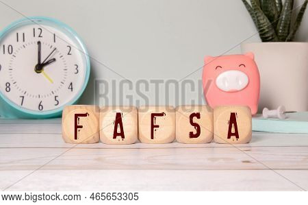 A Wooden Blocks With The Word Fafsa Written On It On A Wooden Background