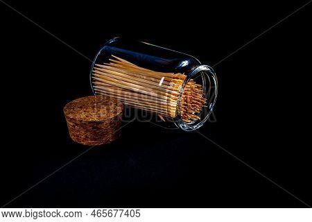 Bamboo Wooden Toothpicks In Glass Jar, Wine Glass. In Bucket. Toothpicks On Black Background. Front