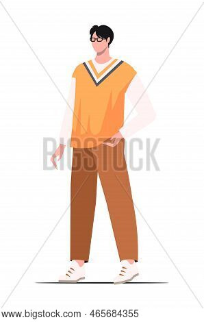 A Young Serious Concentrated  Intelligent Asian Guy With Glasses And A Yellow Vest. Business  Creati
