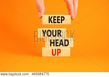 Keep Your Head Up Symbol. Concept Words Keep Your Head Up On Wooden Cubes. Beautiful Orange Table Or