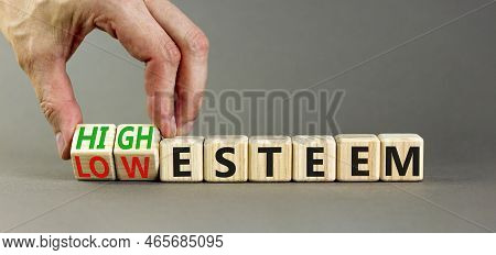 High Or Low Esteem Symbol. Concept Words High Esteem And Low Esteem On Wooden Cubes. Businessman Han