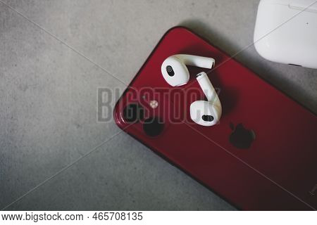 Bangkok, Thailand - November 19, 2022 : Airpods 3 Bluetooth Headphones Placed On Red Iphone 11. Top 