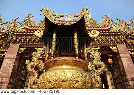 An Ornate Golden Incense Burner In Front Of A Chinese Buddhist Shrine