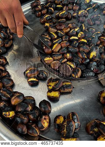Fried Chestnuts On The Street. Street Food. Roasted Chestnuts