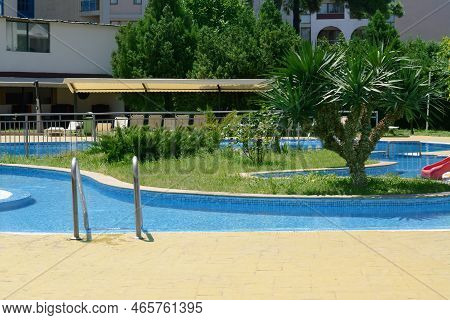Terrace Of Hotel With Swimming Pool And Tropical Plants On Sunny Day