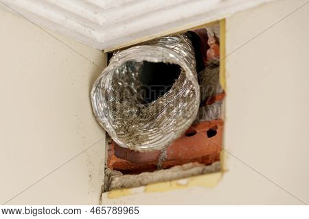 Old Flexible Aluminum Ventilation Duct With Dust Close Up. Broken Vent System In The Room