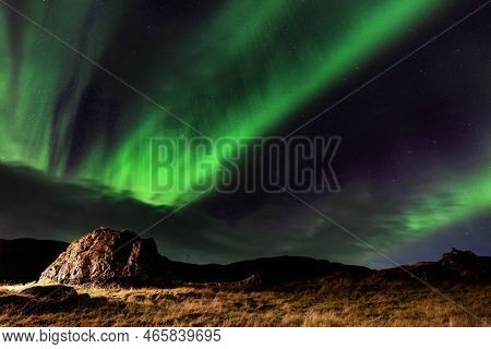 Northern Lights, Aurora Borealis In The Night Sky, Iceland. These Colourful Curtains Of Dancing Ligh