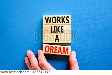 Works Like A Dream Symbol. Concept Words Works Like A Dream On Wooden Cubes. Beautiful Blue Table Bl