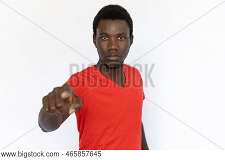 Serious Man Pointing At Camera. Young African American Male Model Pointing At Camera With Serious Ex