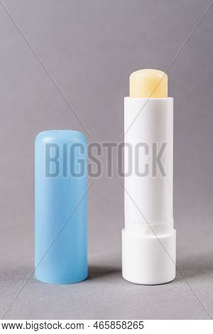 Chapstick Open Tube Over Gray Background. Moisturizing Lip Balm For Dry Lips Macro. Colorless Protec
