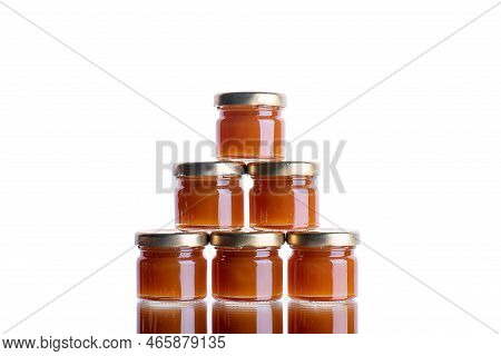 Jam In Many Jars On A White Isolated Background With Reflection. Orange Jelly Apricot Apple. Concept