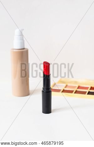 Beautiful Red Lipstick, Macara, Eye Shadows And Tone Cream On White Background. Professional Makeup 