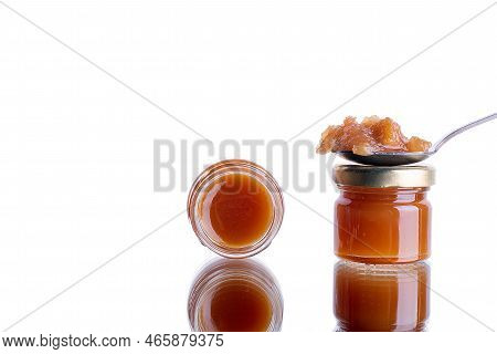 Jam In A Jar And A Spoon. Apple And Pear Jam In A Spoon On A White Mirror Background. Healthy Natura