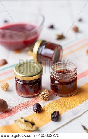 Jam In A Jar And A Spoon. Apple And Pear Jam In A Spoon On A White Mirror Background. Healthy Natura