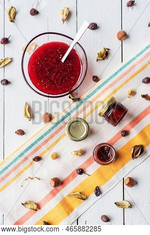 Jam In A Jar And A Spoon. Apple And Pear Jam In A Spoon On A White Mirror Background. Healthy Natura