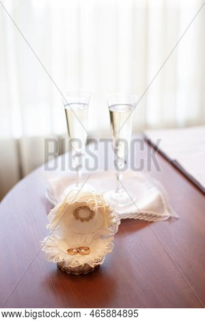 Wedding Gold Rings On The Table In The Registry Office. Wedding Celebration. Concept For Event Agenc