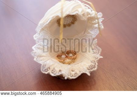 Wedding Gold Rings On The Table In The Registry Office. Wedding Celebration. Concept For Event Agenc