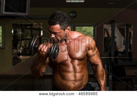 Bodybuilder Doing Heavy Weight Exercise For Biceps With Dumbbell