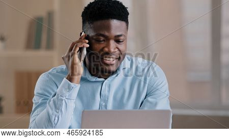 Smiling African Man Male Businessman Employee Freelancer Multitasking Worker Sit At Home Office Talk