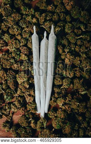 Joints Are On The Table. Three Crossed Joints In Marijuana Buds, Indica Sativa сbd Medicinal.