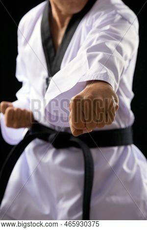 Black Red Belt Taekwondo Karate Male Athlete Man Show Traditional Fighting Poses Punch On Black Back