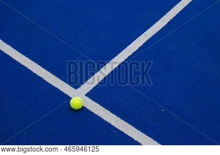 Ball Next To The Line On A Blue Paddle Tennis Court