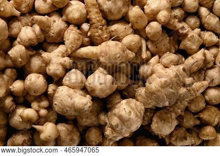 Raw Jerusalem Artichoke Root, Sunchokes As Background.
