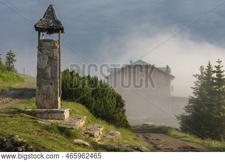 Stone Bell Tower And Old Stone Mountain  Cottage In Jeseniky Mountains On A Summer Foggy Morning