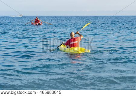 Savona, Italy - August, 16, 2019: Italian Lifeguards Swimming In Kayak. Associazione Marinai Di Salv