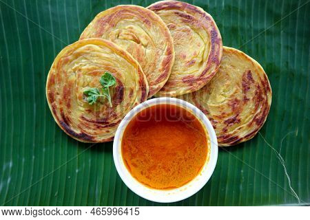 Paratha Bread Or Canai Bread Or Roti Maryam, Favorite Breakfast Dish. Served On Banana Leave