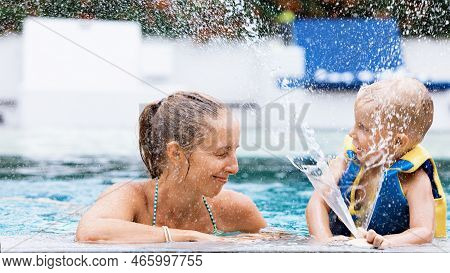 Happy People Have Fun At Pool Side Edge. Funny Photo Of Young Mother With Child Relaxing In Outdoor 