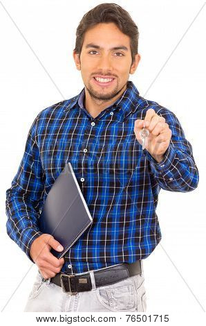 portrait of handsome hispanic male real estate agent holding a key
