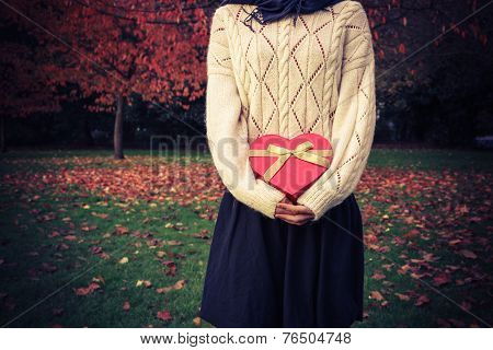 Woman With Heart Shaped Box In Park