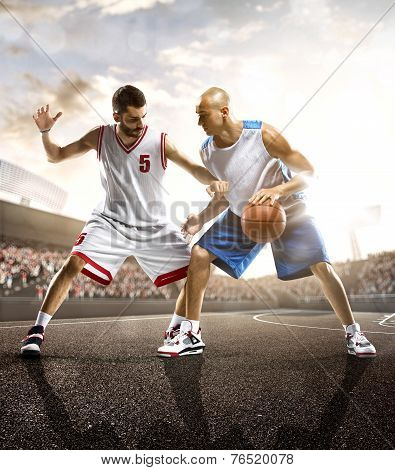 Basketball players in action on background of sky