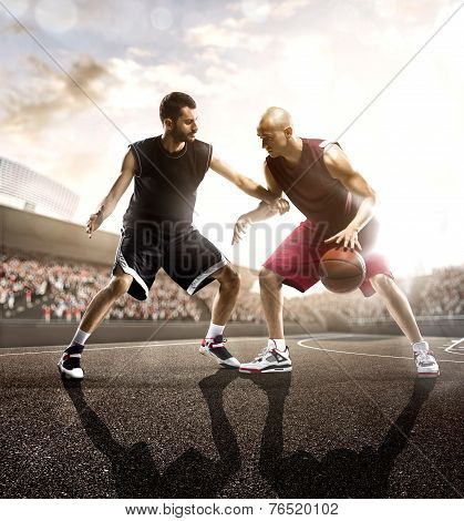 Basketball players in action on background of sky