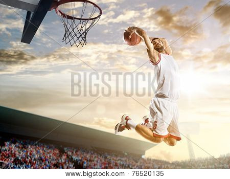 Basketball player in action on background of sky