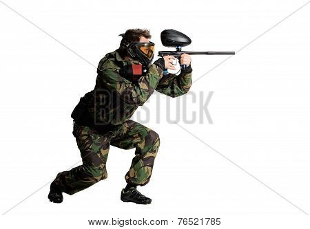Painball player in action isolated