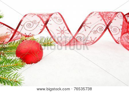 Red Christmas Bauble And Needles Fir And Ribbon On Snow