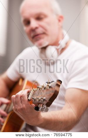 Mature Man Playing Guitar At Home